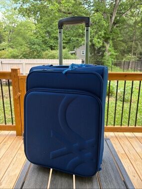 United Colors Of Benetton light Blue Softside Carry-On with Telescoping Handle